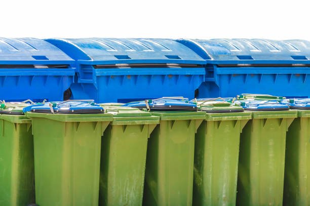 large blue and small green waste containers isolated on a white background